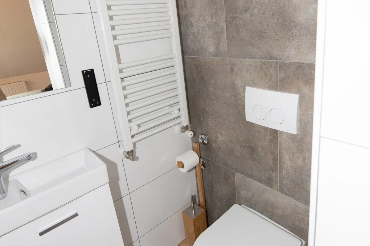 Private bathroom with wall-hung WC and heated towel rail in Woody 1 studio apartment, Zagreb