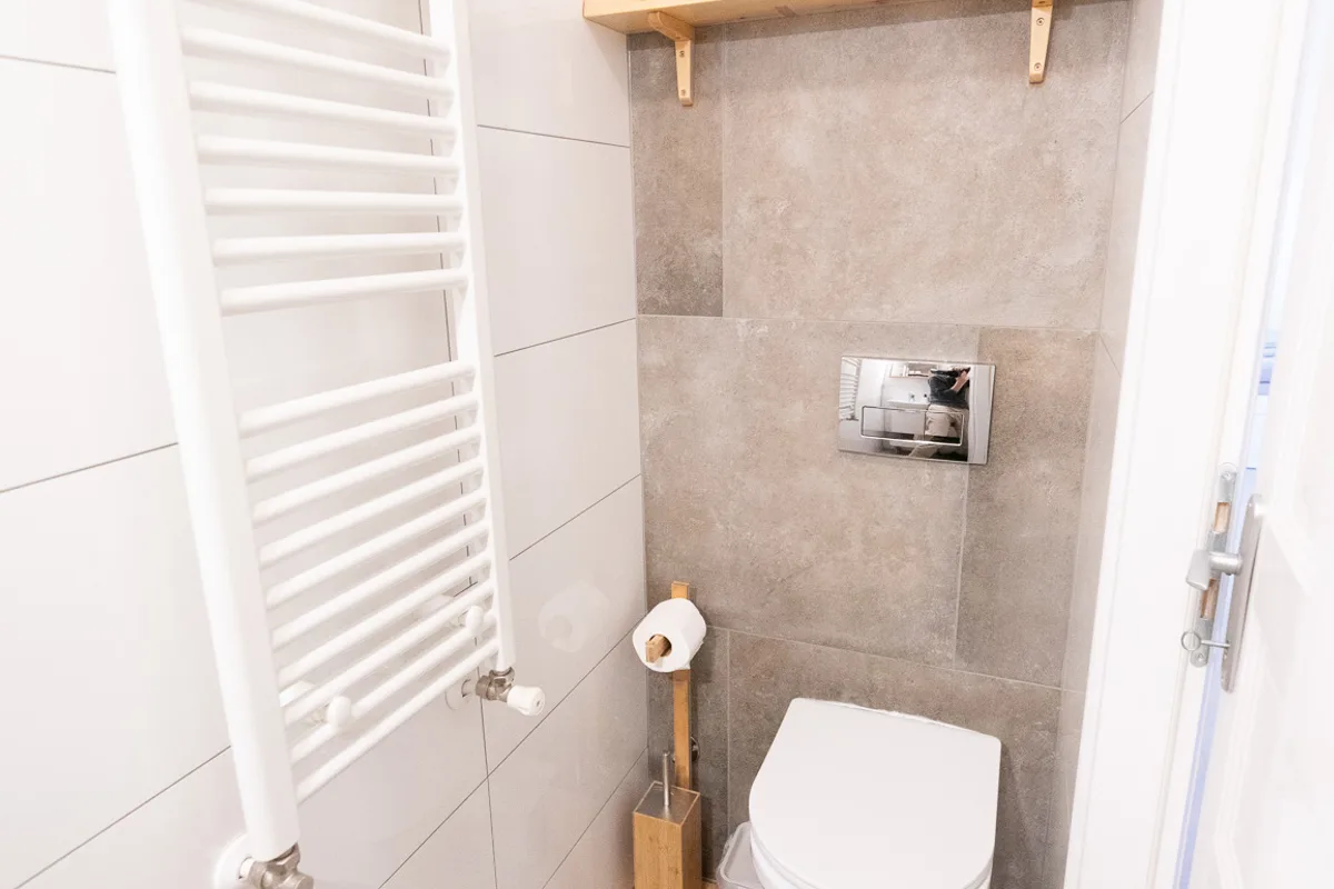 Private bathroom with wall-hung WC and heated towel rail in Woody 3 studio apartment, Zagreb