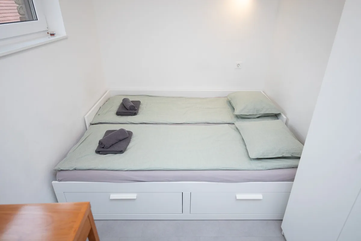 The same alcove bed pulled out to a full double with two duvets in Woody 3, Zagreb