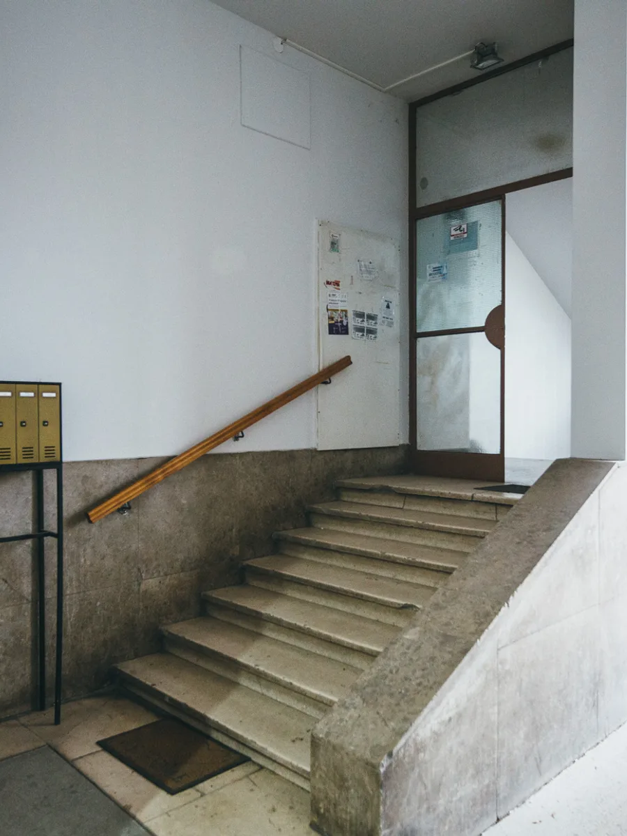 Communal entrance hall with yellow letterboxes and stairs at Petrinjska 51, Zagreb