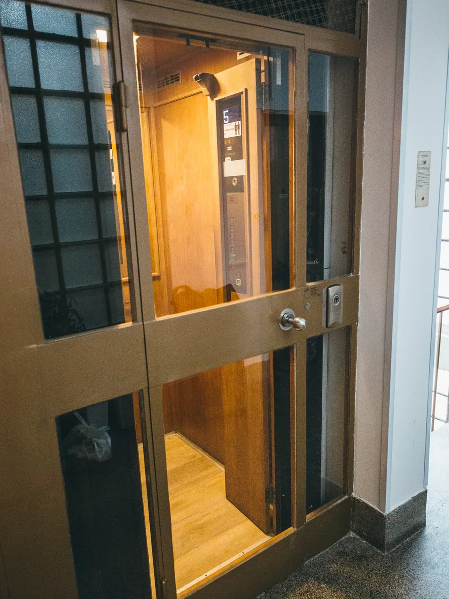 Wood-panelled lift serving the upper floors at Petrinjska 51, Zagreb